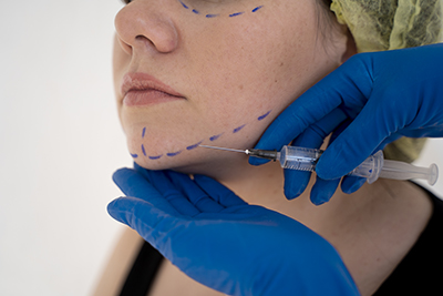 close-up-hands-giving-injection-young-woman