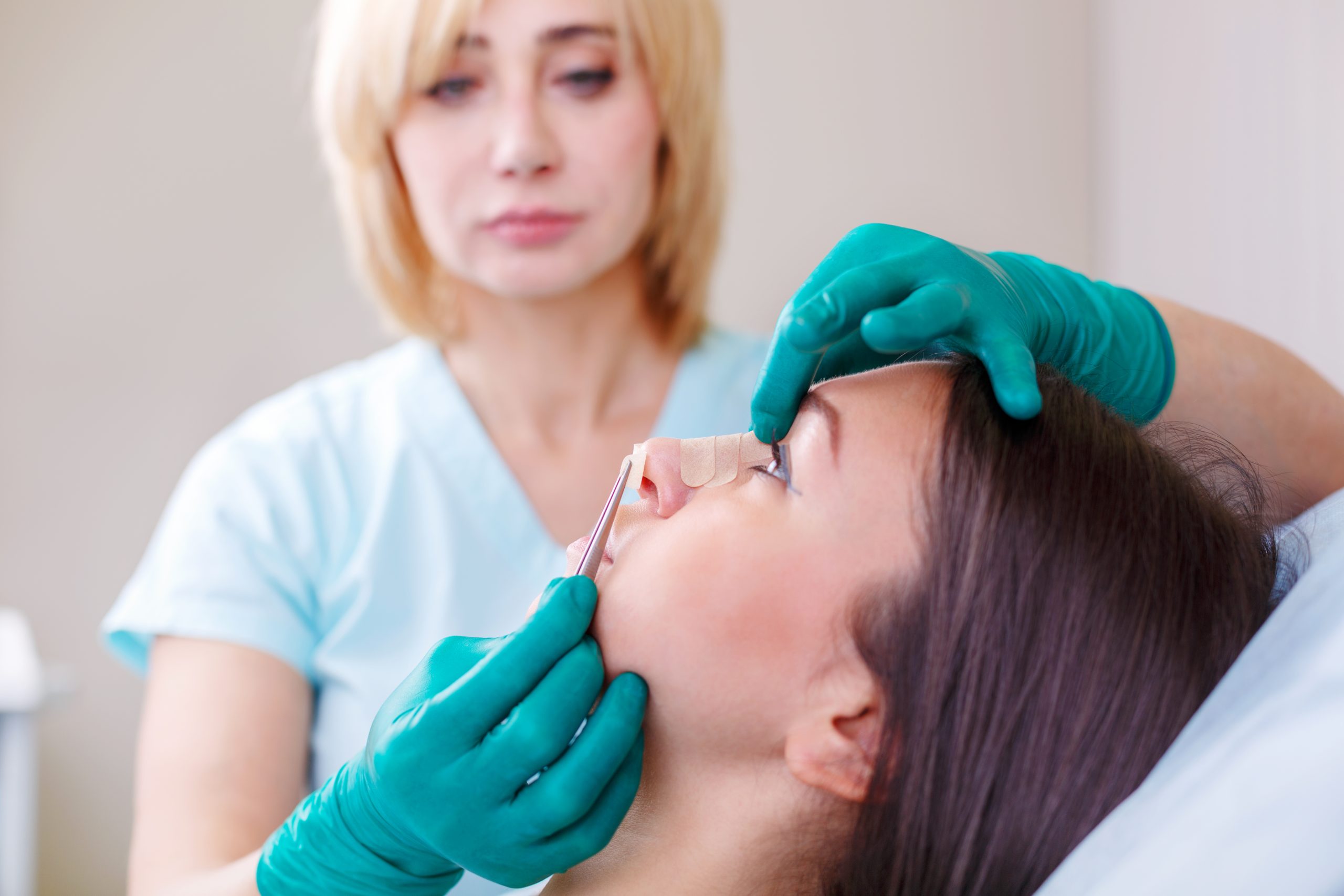 Doctor checking woman’s face, the eyelid before plastic surgery,