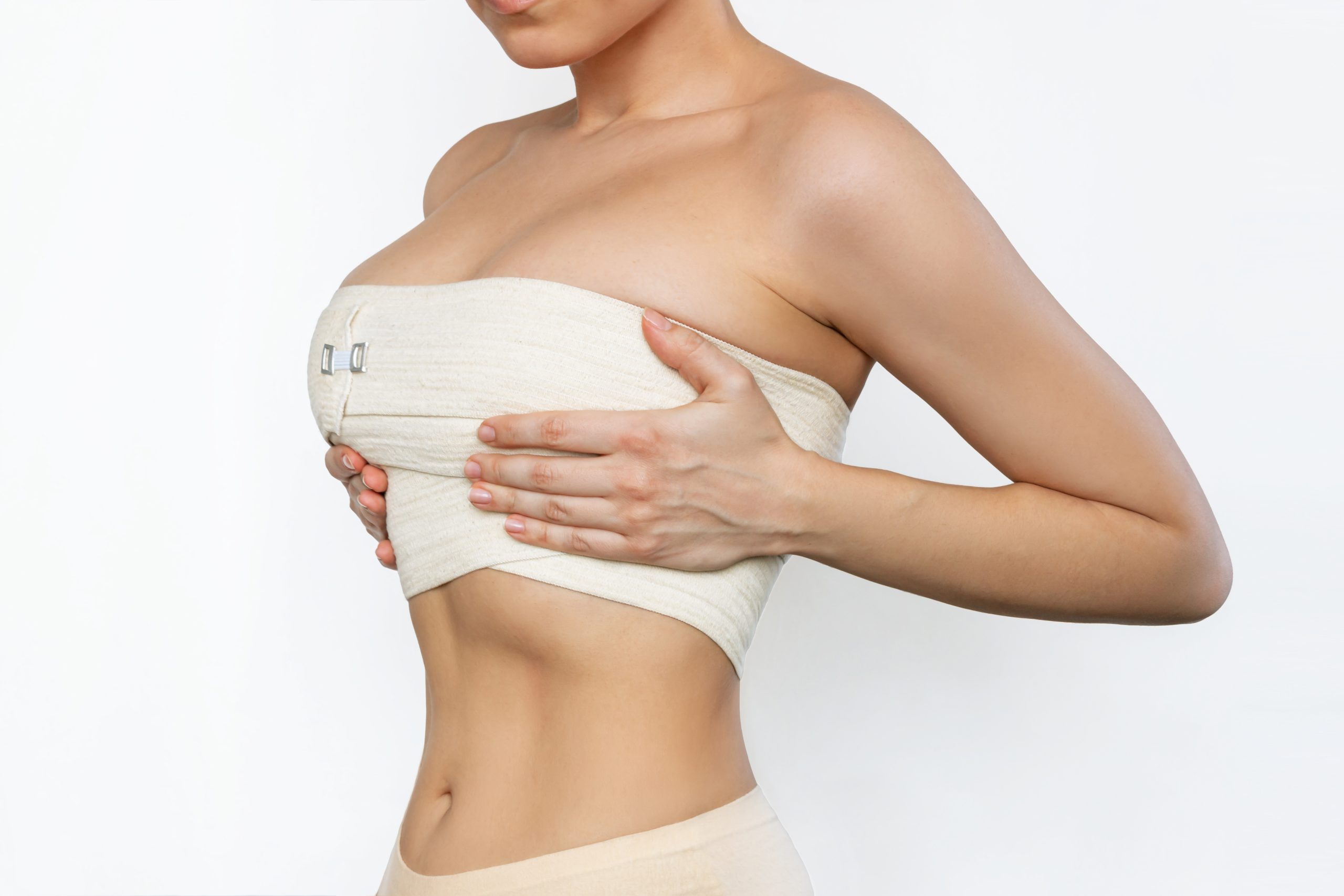 cropped-shot-young-fit-woman-wrapped-elastic-bandage-after-breast-augmentation