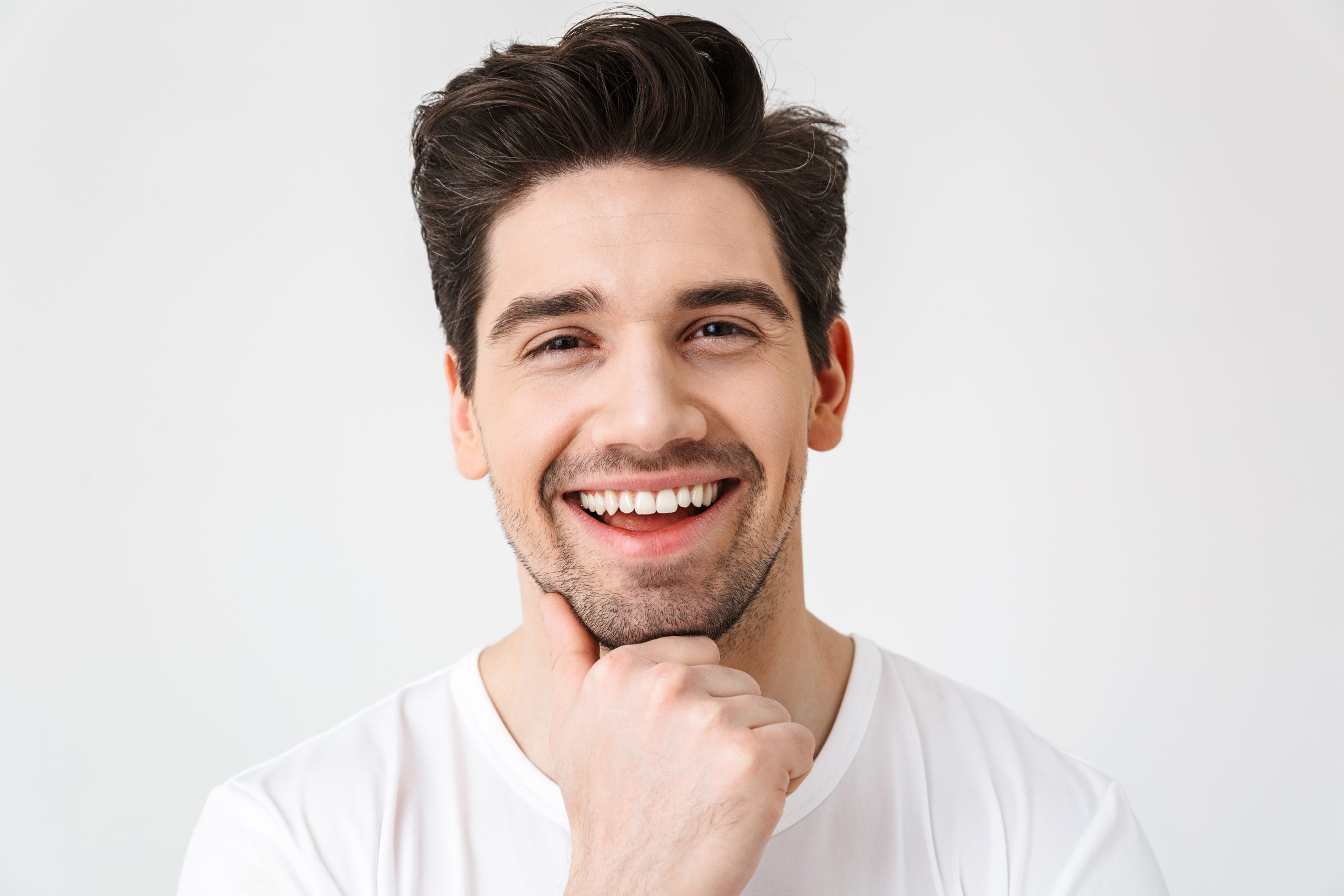 Happy young excited emotional man posing isolated over white wall background.